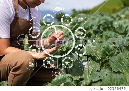Agriculture technology farmer woman holding tablet or tablet technology to research about agriculture problems analysis data and visual icon.Smart farming . Agriculture technology farmer woman holding tablet or tablet technology to research about agriculture problems analysis data and visual icon.Smart farming . 92326476