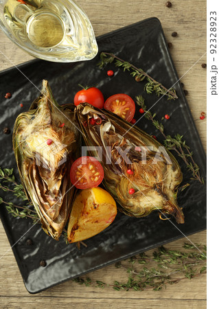 Concept of tasty food with grilled artichoke, top view 92328923