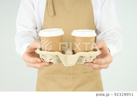 Waiter or barista holds holder with paper cups Waiter or barista holds holder with paper cups 92328951