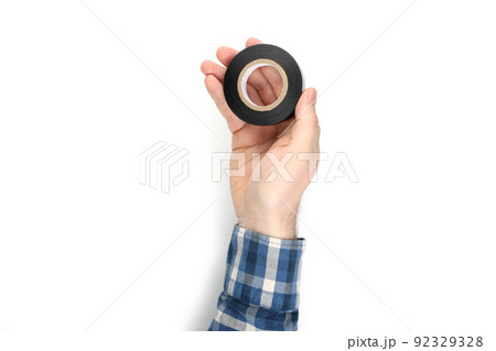 Male hand holds insulating tape, isolated on white background 92329328