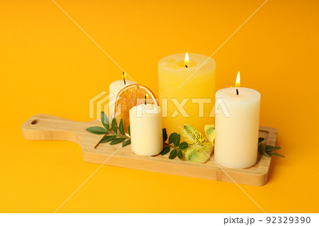 Concept of relaxation with aroma candles on orange background 92329390