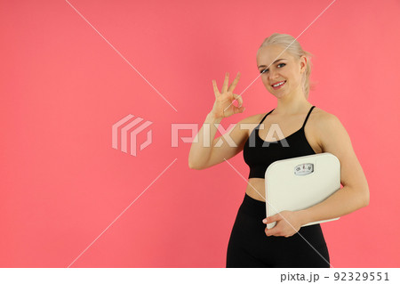 Concept of healthy lifestyle with sporty woman on pink background Concept of healthy lifestyle with sporty woman on pink background 92329551