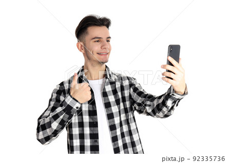 Guy in shirt with phone isolated on white background 92335736