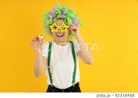 Concept of April Fool's Day on yellow background 92338488