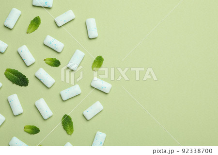 Chewing or bubble gum and mint on green background Chewing or bubble gum and mint on green background 92338700