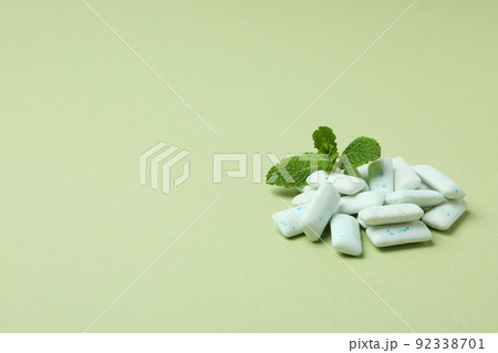Chewing or bubble gum and mint on green background Chewing or bubble gum and mint on green background 92338701