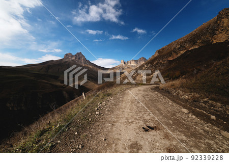 Autumn day on a scenic but difficult 4X4 track located in front of the summit. Off-road, wide angle Autumn day on a scenic but difficult 4X4 track located in front of the summit. Off-road, wide angle 92339228
