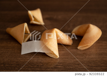 Few fortune cookies with blank paper slip for your wish good luck on table surface Few fortune cookies with blank paper slip for your wish good luck on table surface 92339322