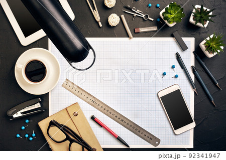 Top view of the builder's workplace, ruler, paper for drawings, compasses, glasses, tablet 92341947