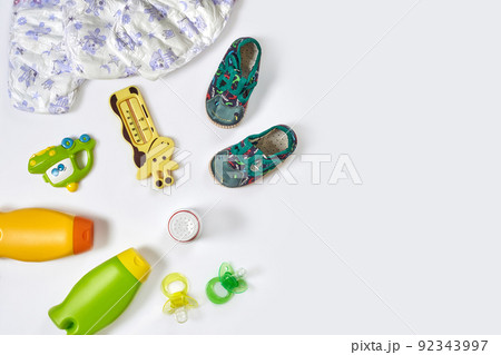 Set of accessories for baby. Pacifier, bottle, diaper, cream on white background. Set of accessories for baby. Pacifier, bottle, diaper, cream on white background. 92343997