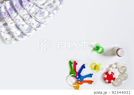 Babies goods diaper, soother or nipple on white background with copy space. Top view or flat lay. 92344031