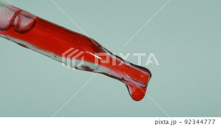 A drop of blood drips from the pipette. Blood for injection plasmolifting, plasma therapy. Cosmetic procedure for the skin of the face using blood. The concept of skin care. High quality photo A drop of blood drips from the pipette. Blood for injection plasmolifting, plasma therapy. Cosmetic procedure for the skin of the face using blood. The concept of skin care. High quality photo 92344777