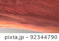 Abstract dark red background. Dramatic red sky. Red sunset with clouds. Fantastic sunset background with copy space for design. Halloween, armageddon, apocalypse, end of the world concept. 92344790