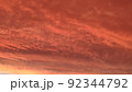 Abstract dark red background. Dramatic red sky. Red sunset with clouds. Fantastic sunset background with copy space for design. Halloween, armageddon, apocalypse, end of the world concept. 92344792