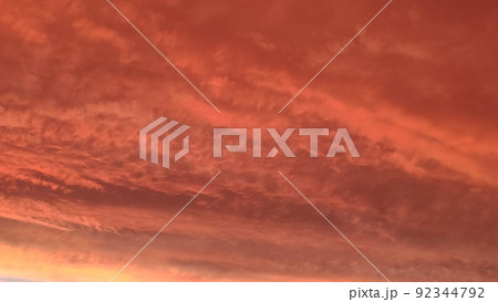 Abstract dark red background. Dramatic red sky. Red sunset with clouds. Fantastic sunset background with copy space for design. Halloween, armageddon, apocalypse, end of the world concept. 92344792