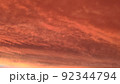 Abstract dark red background. Dramatic red sky. Red sunset with clouds. Fantastic sunset background with copy space for design. Halloween, armageddon, apocalypse, end of the world concept. 92344794