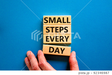 Small steps every day symbol. Concept words Small steps every day on wooden blocks. Businessman hand. Beautiful blue table blue background. Small steps every day business concept. Copy space. Small steps every day symbol. Concept words Small steps every day on wooden blocks. Businessman hand. Beautiful blue table blue background. Small steps every day business concept. Copy space. 92346987