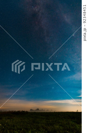 A natural landscape at night. The Milky Way galaxy, many stars, and the Andromeda galaxy above the fog field at midnight 92348451