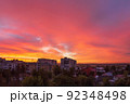 Bright coral sky before dawn in a provincial residential area of the city with high-rise buildings. Cityscape. 92348498