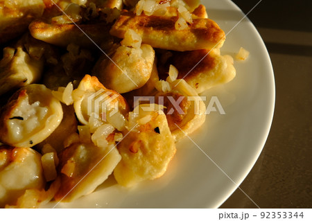 Homemade potato dumplings or vereniki pierogi, served with fried onions. Rustic style, comfort eastern europe cuisine Homemade potato dumplings or vereniki pierogi, served with fried onions. Rustic style, comfort eastern europe cuisine 92353344