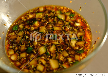 Soy sauce in a glass bowl with some vegetables. Soy sauce in a glass bowl with some vegetables. 92353345