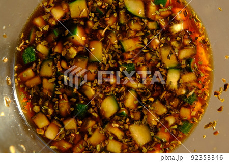 Soy sauce in a glass bowl with some vegetables. Soy sauce in a glass bowl with some vegetables. 92353346