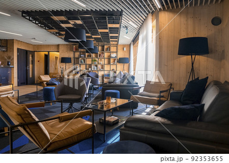 Cozy chairs and sofa arranged in beautiful lounge at luxurious hotel 92353655