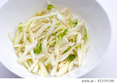 Sliced fresh fennel in white bowl on white background. Sliced fresh fennel in white bowl on white background. 92354196