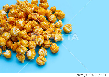Honey caramel popcorn on white background. Honey caramel popcorn on white background. 92354281