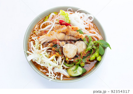 Thai rice noodle with chicken feet curry and fish balls Thai rice noodle with chicken feet curry and fish balls 92354317