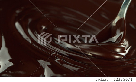 Close-up of stirring stream of melted chocolate. 92355671