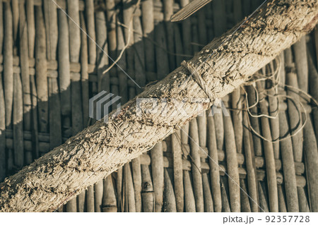 Old woven bamboo rug, rough textile wide rope, fragment banner frame border. Diagonal lines, contrast shadow. Copy space for text. Abstract background. Light brown beige grey tones more in stock Old woven bamboo rug, rough textile wide rope, fragment banner frame border. Diagonal lines, contrast shadow. Copy space for text. Abstract background. Light brown beige grey tones more in stock 92357728