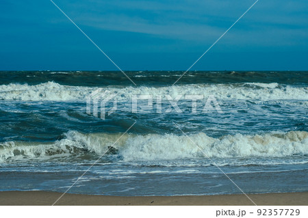 Ocean storm waves dramatically crashing splashing. Sky horizon line. Sea water edge, nature front view marine wallpaper. Bad weather cloudy overcast. Dark green turquoise blue bright vivid contrast Ocean storm waves dramatically crashing splashing. Sky horizon line. Sea water edge, nature front view marine wallpaper. Bad weather cloudy overcast. Dark green turquoise blue bright vivid contrast 92357729