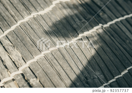 Old woven bamboo rug, rough texture dirty, fragment banner. Diagonal horizontal vertical lines, contrast shadow. Copy space for text. Abstract background. Light brown beige grey tones more in stock Old woven bamboo rug, rough texture dirty, fragment banner. Diagonal horizontal vertical lines, contrast shadow. Copy space for text. Abstract background. Light brown beige grey tones more in stock 92357737