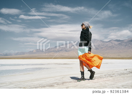 asian woman female tourist in long skirt walking on saline alkali land asian woman female tourist in long skirt walking on saline alkali land 92361384