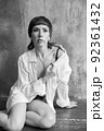 A sensual portrait of a girl with an emotional face and sensual eyes in a white shirt. 92361432