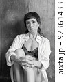 A sensual portrait of a girl with an emotional face and sensual eyes in a white shirt. 92361433