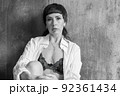 A sensual portrait of a girl with an emotional face and sensual eyes in a white shirt. 92361434