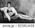 A sensual portrait of a girl with an emotional face and sensual eyes in a white shirt. 92361438