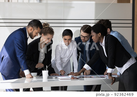 Multiethnic millennial business group of employees discussing project Multiethnic millennial business group of employees discussing project 92362469