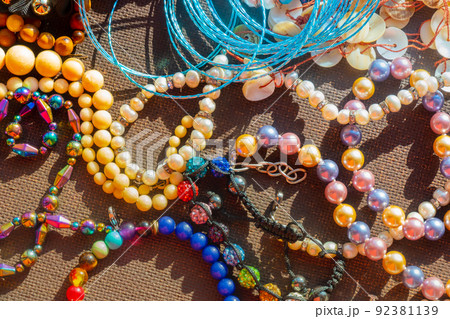 a lot of costume jewelry with different materials on a black background 92381139