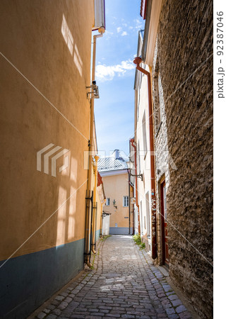 Empty cobbled alley amidst residential buildings in old town at city against sky 92387046