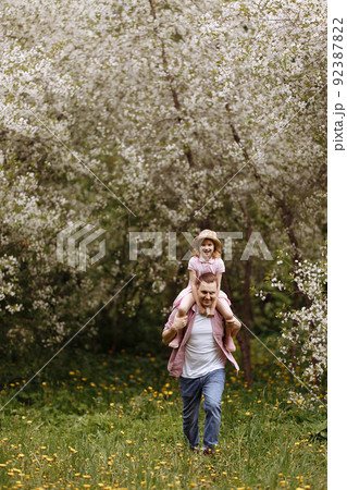 Father and little daughter are walking. Father and little daughter are walking. 92387822