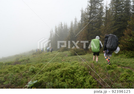 Tourist hike with large backpacks in the Carpathians. Tourist hike with large backpacks in the Carpathians. 92396125