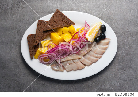 cold appetizer - salted herring with potatoes and red onion 92398904