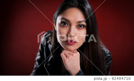 Young pretty woman in black leather jacket posing for the camera 92404710