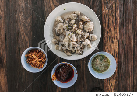 Thai seafood Fresh Oyster with three sauces served on wooden table. 92405877