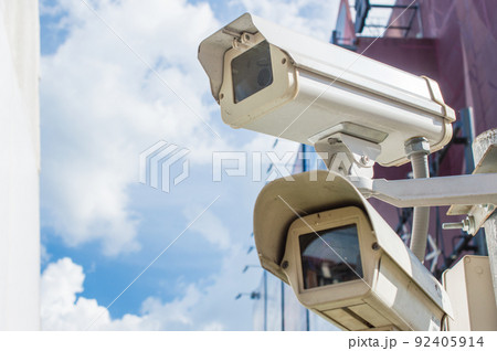 Double security CCTV camera outside the office building. Surveillance camera used for the purpose of observing an area. Double security CCTV camera outside the office building. Surveillance camera used for the purpose of observing an area. 92405914