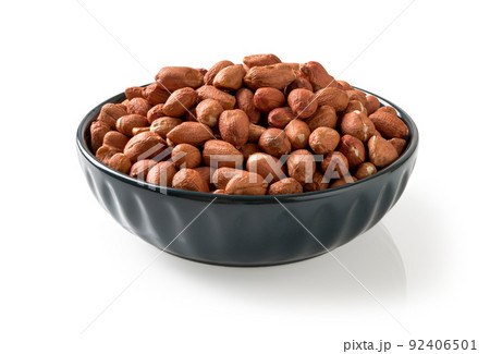 Closeup of raw peanut in a blue bowl isolated on a white background. Closeup of raw peanut in a blue bowl isolated on a white background. 92406501