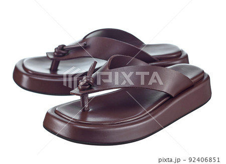 Beautiful pair of brown flip-flops made of genuine leather with stripes-straps on top and a massive high sole. The trend of the season. 92406851
